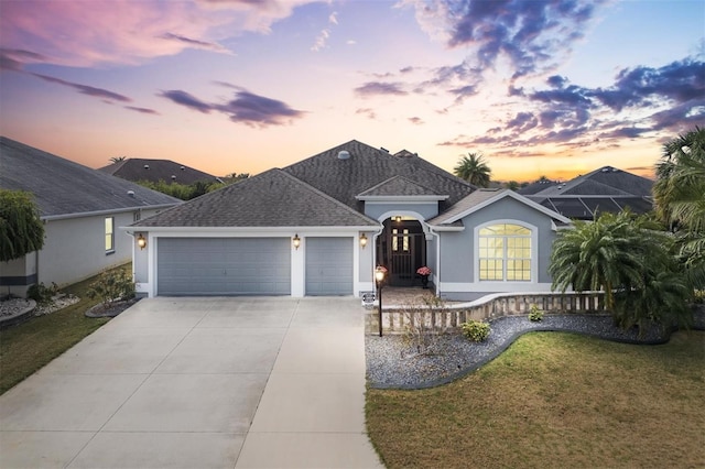 ranch-style house with a yard and a garage