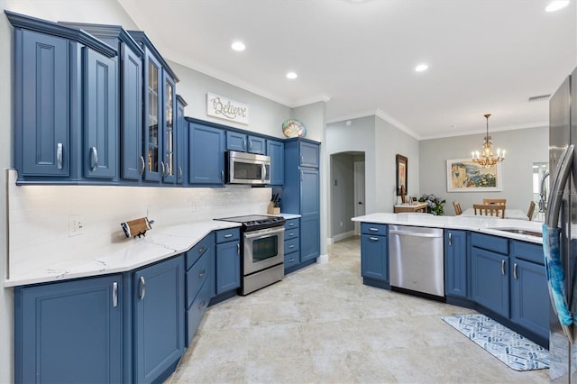 kitchen featuring blue cabinets, decorative backsplash, ornamental molding, a notable chandelier, and stainless steel appliances