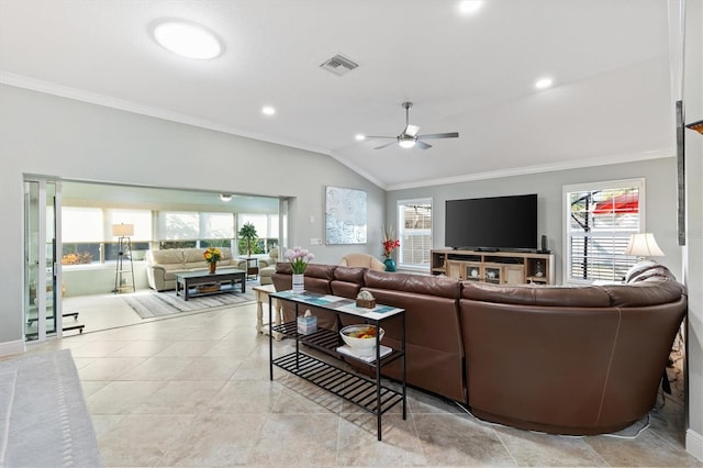 living room with crown molding, lofted ceiling, and plenty of natural light