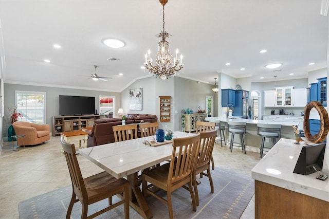 tiled dining space with lofted ceiling, ornamental molding, and ceiling fan