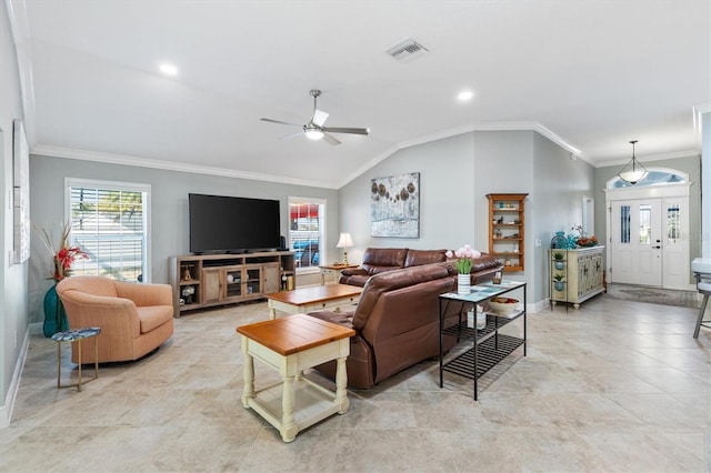 living room with plenty of natural light, ornamental molding, ceiling fan, and vaulted ceiling