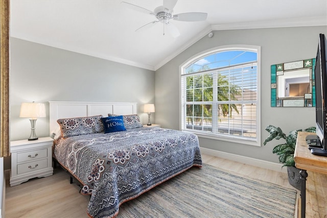 bedroom featuring crown molding, lofted ceiling, and light wood-type flooring