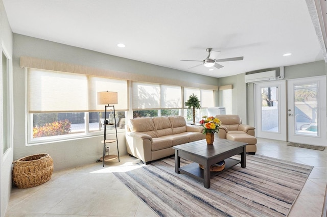 tiled living room featuring a wall unit AC, french doors, and ceiling fan