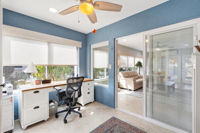 tiled home office featuring ceiling fan and plenty of natural light