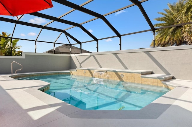 view of swimming pool featuring a lanai