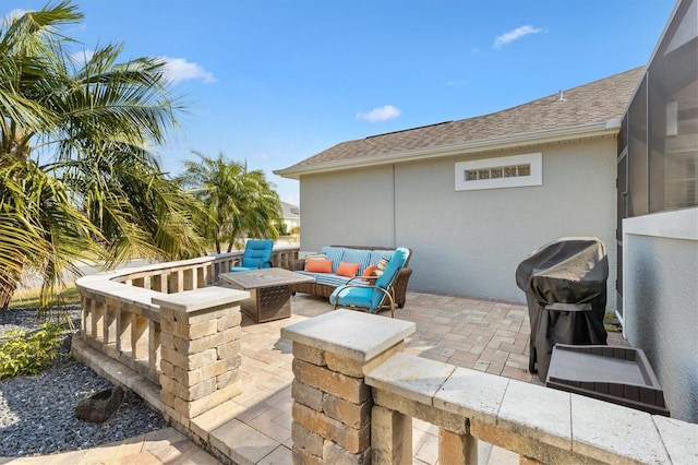 view of patio / terrace with area for grilling and an outdoor living space with a fire pit