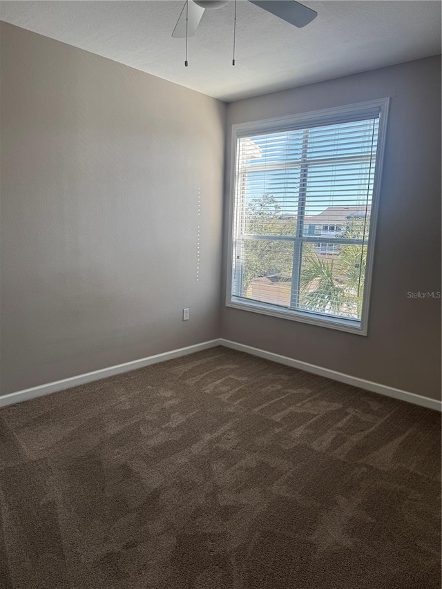 carpeted spare room with ceiling fan