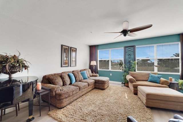 living room with ceiling fan and light hardwood / wood-style flooring