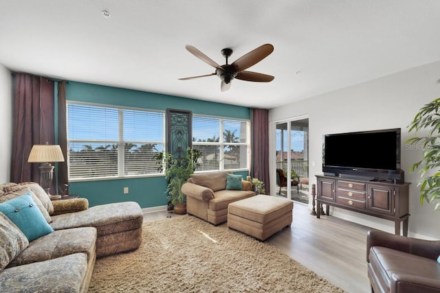 living room featuring ceiling fan and light wood-type flooring