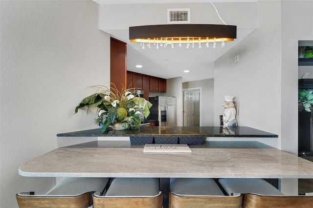 kitchen with kitchen peninsula and stainless steel fridge