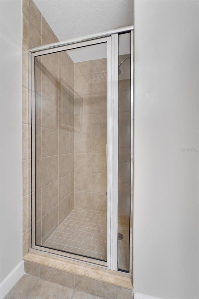 bathroom with a shower with door