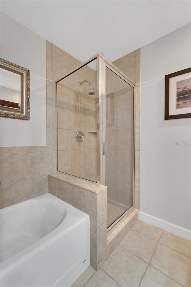 bathroom with separate shower and tub and tile patterned flooring