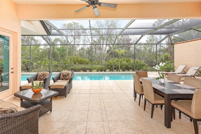 outdoor pool featuring glass enclosure, a patio area, and a ceiling fan