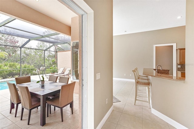 interior space featuring an outdoor pool, glass enclosure, outdoor dry bar, and outdoor dining space