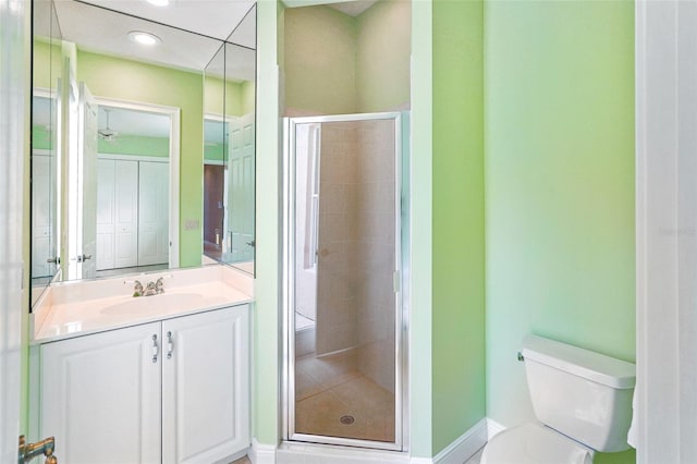 bathroom featuring a stall shower, vanity, toilet, and recessed lighting