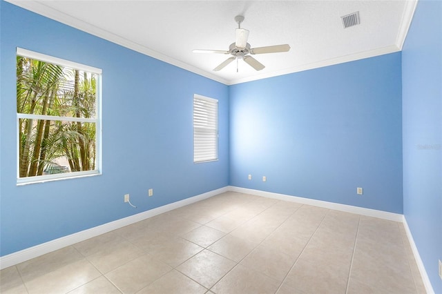 empty room featuring ceiling fan, visible vents, baseboards, and ornamental molding