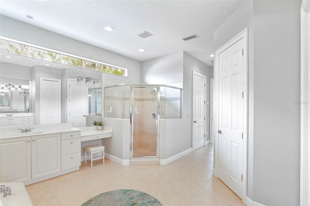 bathroom featuring a stall shower, tile patterned flooring, visible vents, and vanity