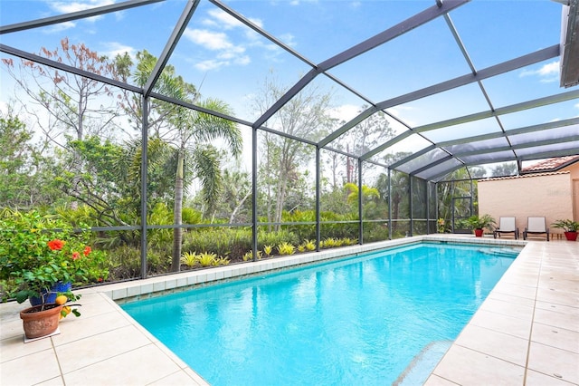 outdoor pool with a lanai and a patio