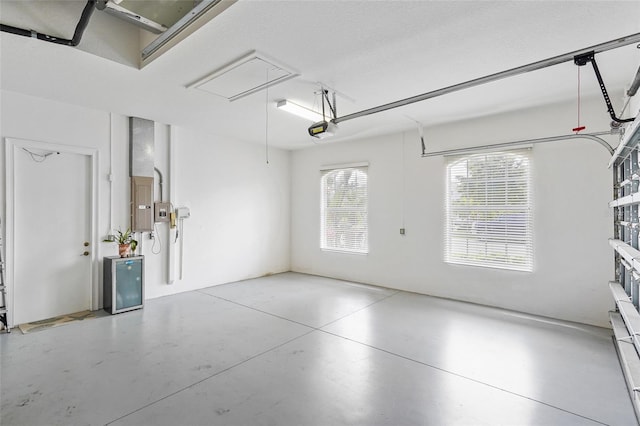 garage featuring electric panel and a garage door opener