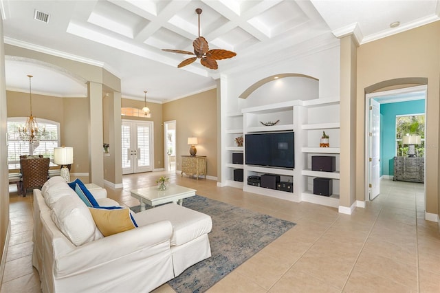 living area with built in features, light tile patterned floors, visible vents, coffered ceiling, and baseboards