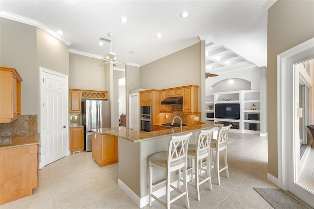 kitchen featuring ceiling fan, under cabinet range hood, stainless steel appliances, a peninsula, and crown molding