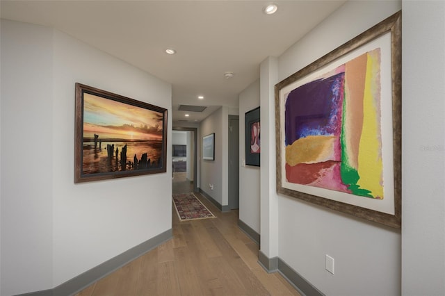 hallway with hardwood / wood-style floors