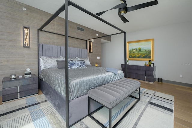 bedroom with ceiling fan and light hardwood / wood-style floors