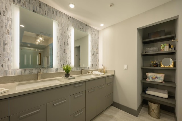 bathroom featuring vanity and a shower with door