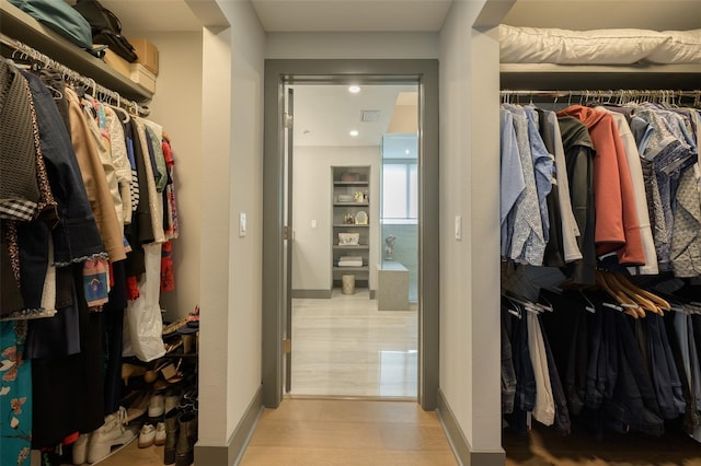 spacious closet featuring light hardwood / wood-style floors