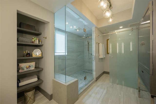 bathroom with a shower with door