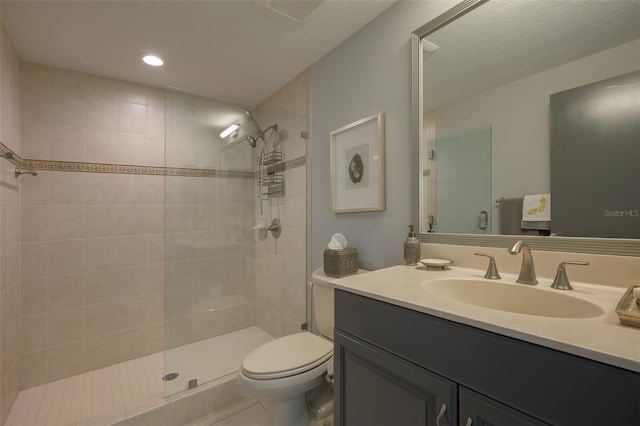 bathroom with toilet, vanity, and walk in shower