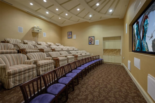 cinema with coffered ceiling and dark carpet