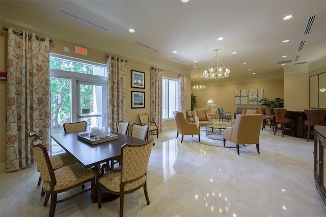 dining area with ornamental molding and an inviting chandelier