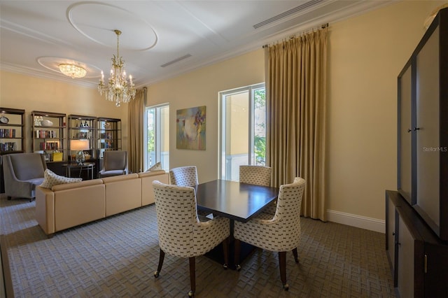 dining room featuring ornamental molding and an inviting chandelier