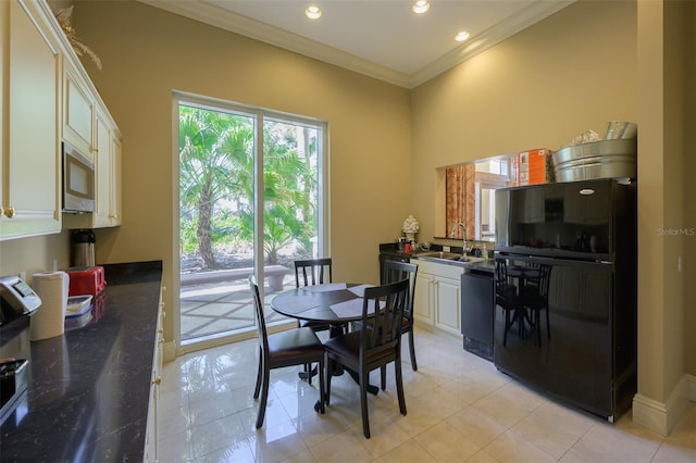 dining room featuring crown molding and sink