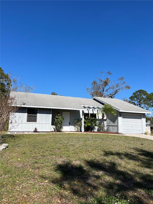 view of front of home featuring a garage and a front lawn