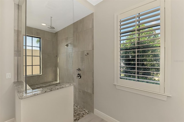 bathroom featuring baseboards and a walk in shower