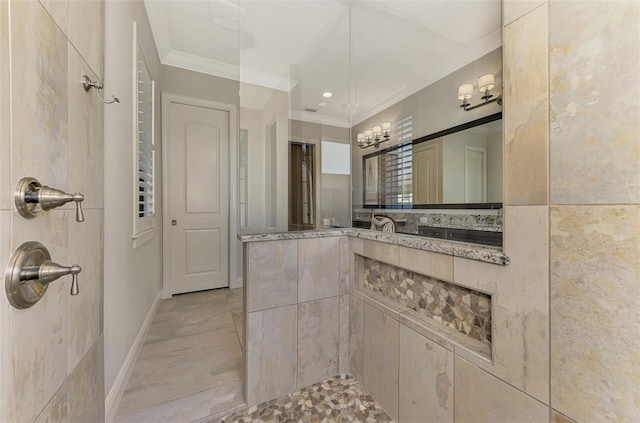 bathroom with baseboards, walk in shower, vanity, and crown molding