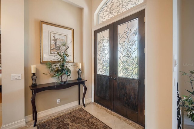 foyer featuring tile patterned flooring, french doors, and baseboards