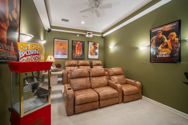 carpeted cinema with ornamental molding, visible vents, baseboards, and a ceiling fan