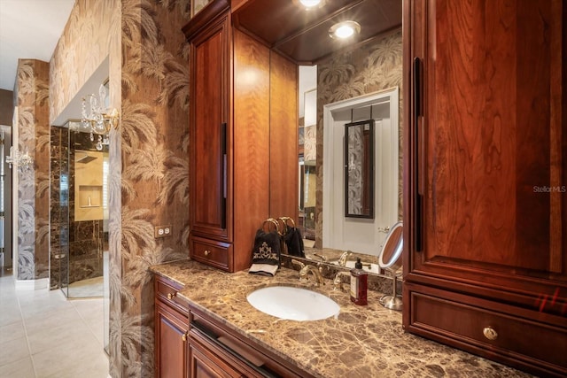 bathroom featuring tile patterned flooring, vanity, and wallpapered walls