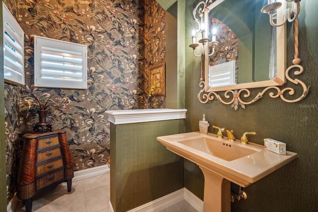 bathroom featuring baseboards, tile patterned flooring, and wallpapered walls