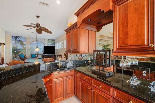 kitchen with visible vents, a ceiling fan, dark stone countertops, a sink, and recessed lighting