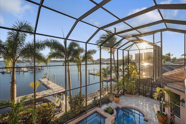 view of pool with a boat dock, an in ground hot tub, a lanai, a water view, and a patio area