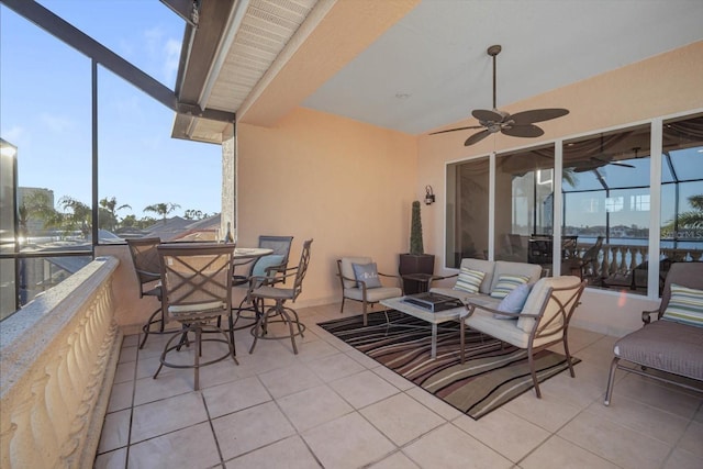 view of patio / terrace with glass enclosure, ceiling fan, and an outdoor living space