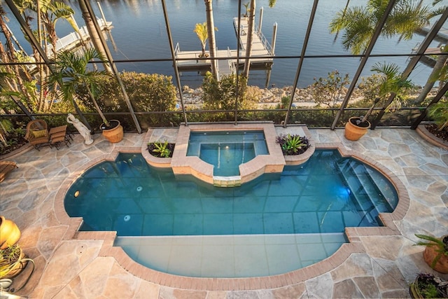 outdoor pool featuring a water view and an in ground hot tub