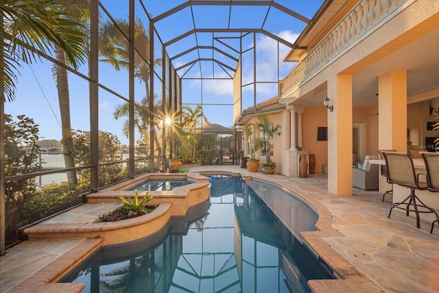 view of pool with a patio, a pool with connected hot tub, a water view, glass enclosure, and ceiling fan