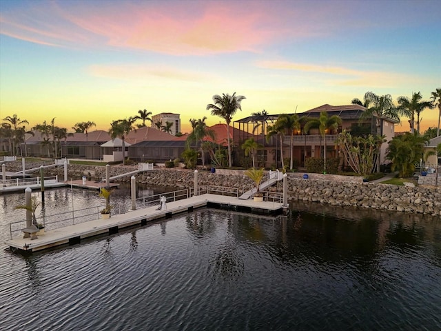 view of dock featuring a residential view and a water view