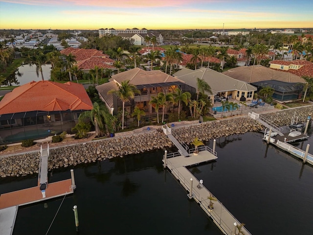 drone / aerial view with a residential view and a water view