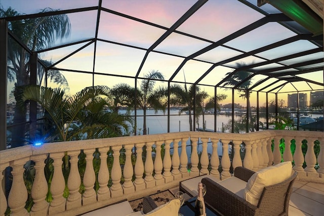 view of patio with a water view, a lanai, and a balcony